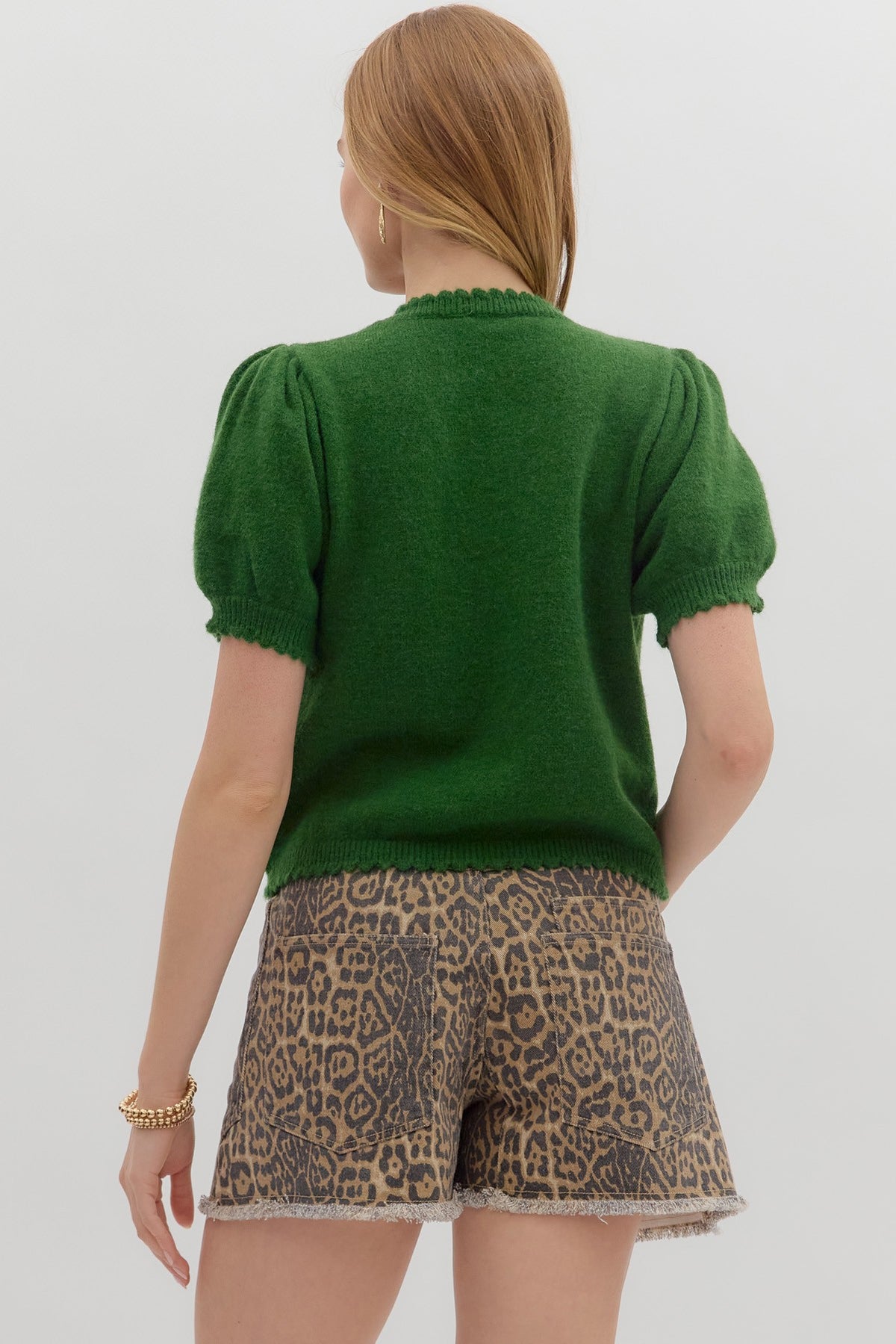 Solid short puff sleeve sweater knit top featuring scallop accent edge